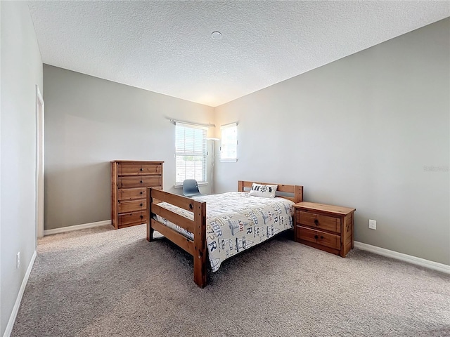 bedroom featuring carpet and a textured ceiling