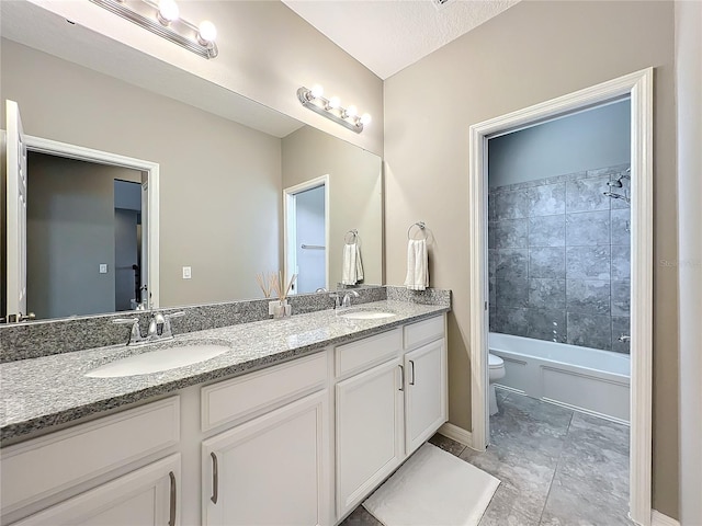 full bathroom with tiled shower / bath combo, vanity, and toilet