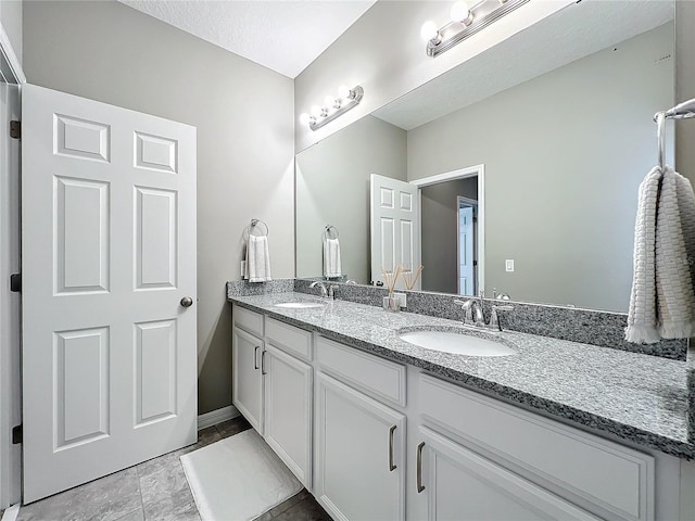 bathroom with vanity and a textured ceiling