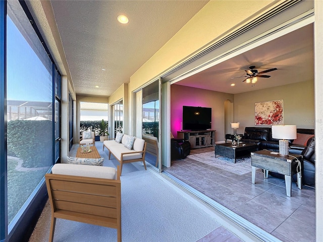 sunroom / solarium featuring ceiling fan