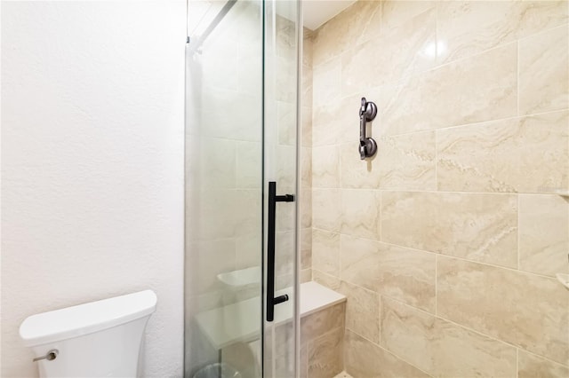 bathroom featuring toilet and walk in shower