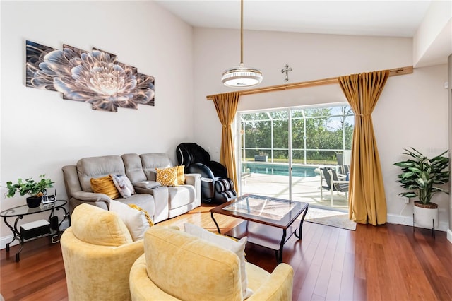 living room with dark hardwood / wood-style floors and high vaulted ceiling