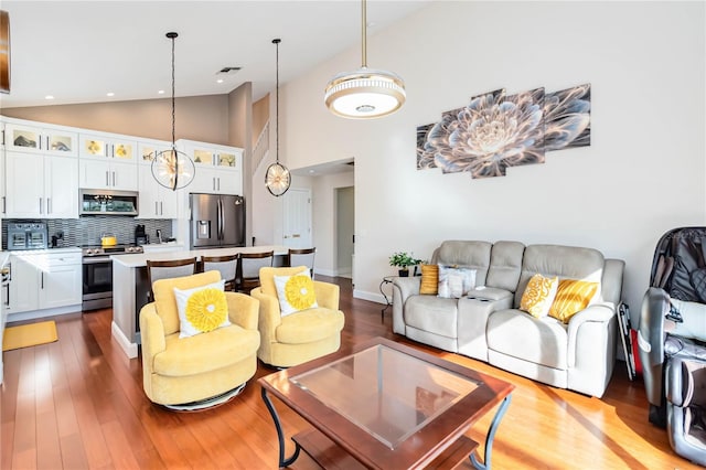 living room featuring hardwood / wood-style flooring and high vaulted ceiling