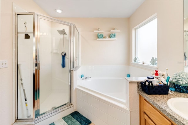 bathroom with vanity and separate shower and tub