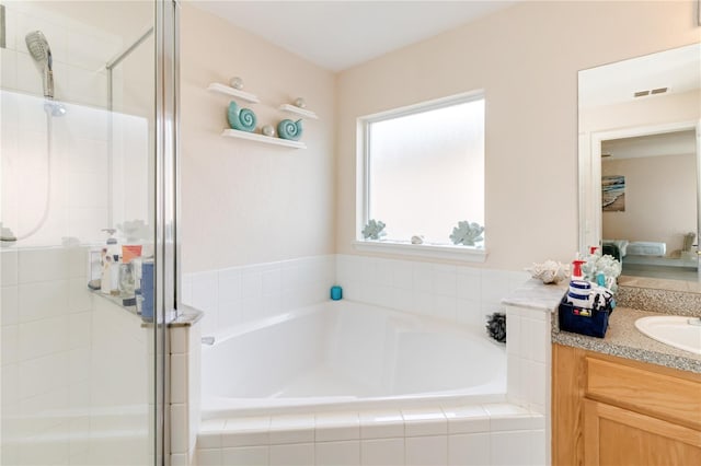 bathroom featuring vanity and plus walk in shower