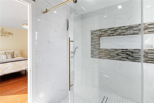 bathroom featuring hardwood / wood-style flooring and an enclosed shower