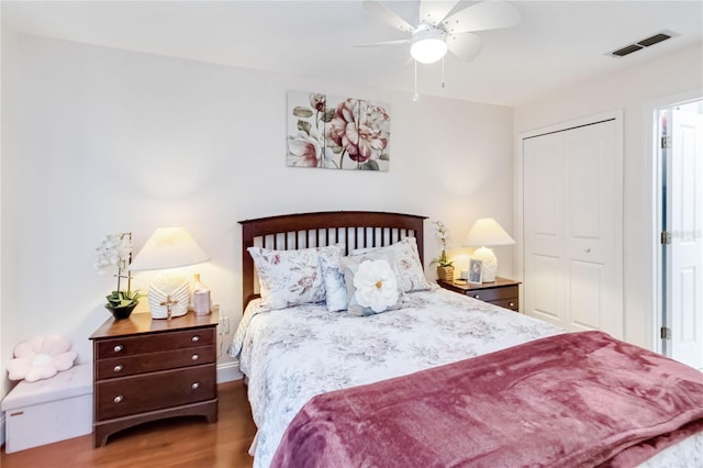 bedroom featuring dark hardwood / wood-style flooring, a closet, and ceiling fan