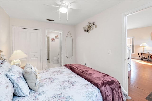 bedroom featuring wood-type flooring, a closet, ceiling fan, and ensuite bathroom