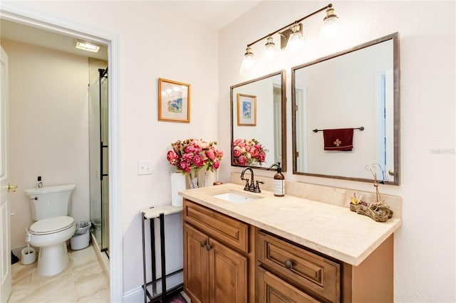 bathroom with vanity, toilet, and a shower with door