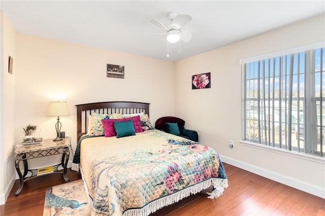 bedroom featuring dark hardwood / wood-style flooring and ceiling fan