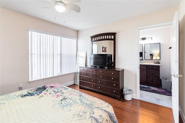 bedroom with ceiling fan, connected bathroom, and dark hardwood / wood-style flooring