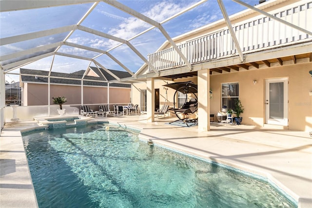 view of swimming pool with an in ground hot tub, a lanai, and a patio