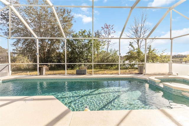 view of pool with a lanai, a patio, and an in ground hot tub