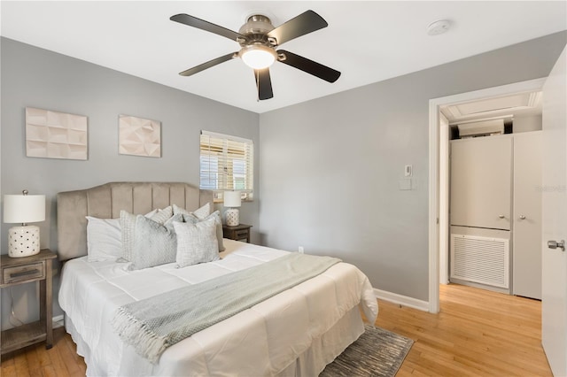 bedroom with light hardwood / wood-style flooring and ceiling fan