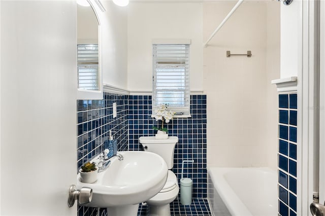 full bathroom featuring tile patterned floors, toilet, sink, tile walls, and shower / bath combination