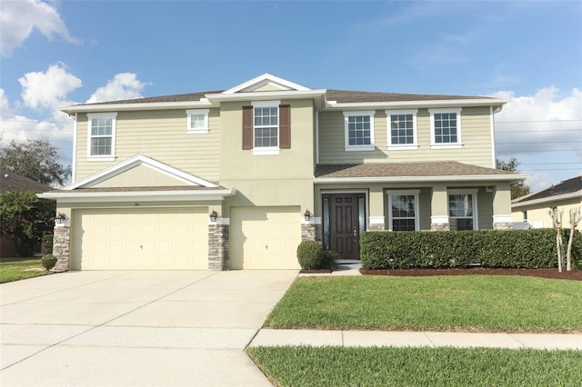 view of front facade with a garage and a front lawn