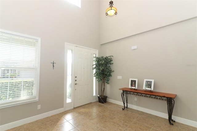 tiled foyer entrance with a high ceiling