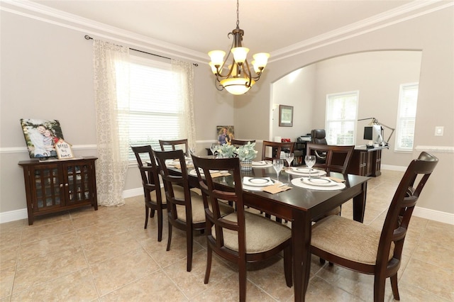 dining room with crown molding, light tile patterned flooring, and a notable chandelier