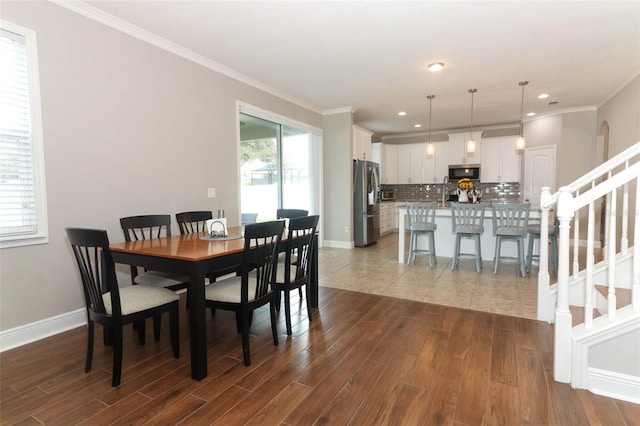 dining space with crown molding, hardwood / wood-style flooring, and a wealth of natural light