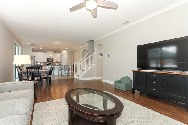 living room featuring crown molding, dark hardwood / wood-style floors, and ceiling fan