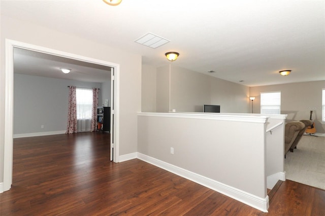 hallway with dark wood-type flooring