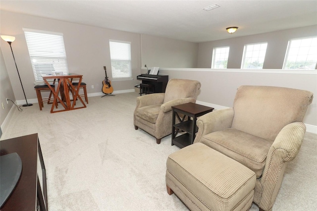 sitting room featuring light carpet