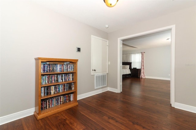 corridor featuring dark wood-type flooring