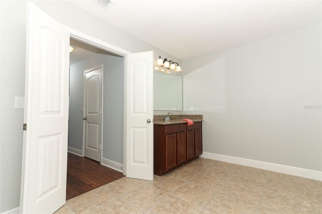 bathroom featuring tile patterned flooring and vanity