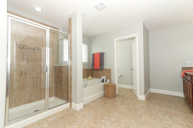 bathroom featuring independent shower and bath, vanity, and tile patterned floors