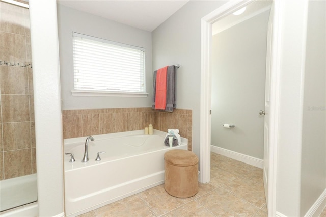 bathroom featuring tile patterned floors and shower with separate bathtub