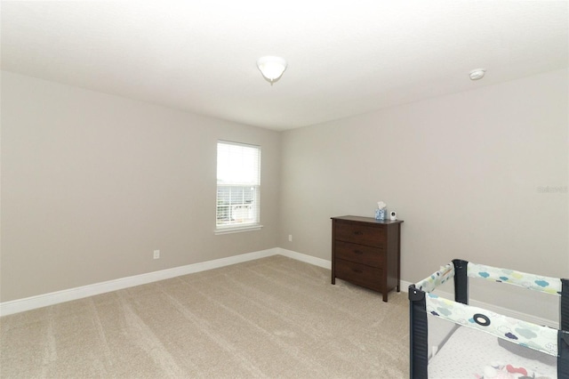 bedroom featuring light carpet