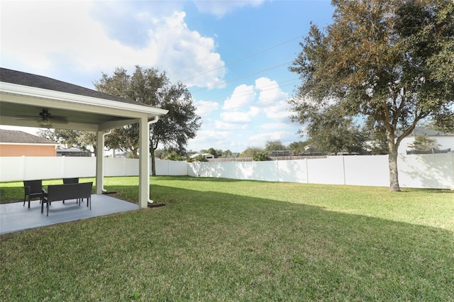 view of yard with ceiling fan and a patio area