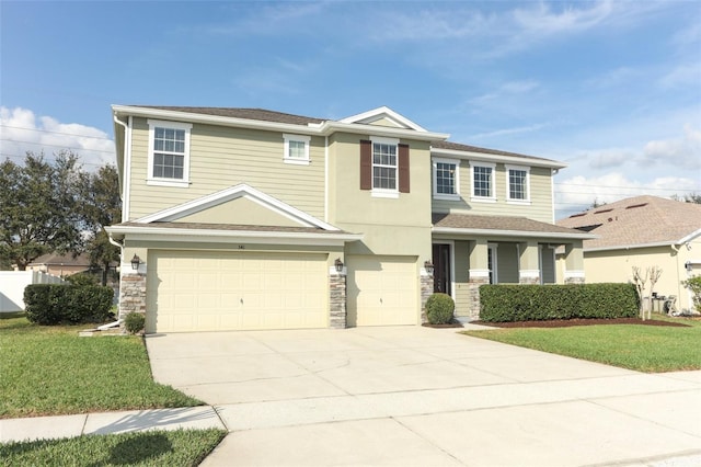 view of front of home featuring a garage and a front yard