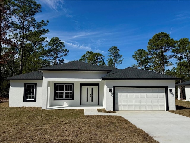 view of front of house featuring a garage and a front yard