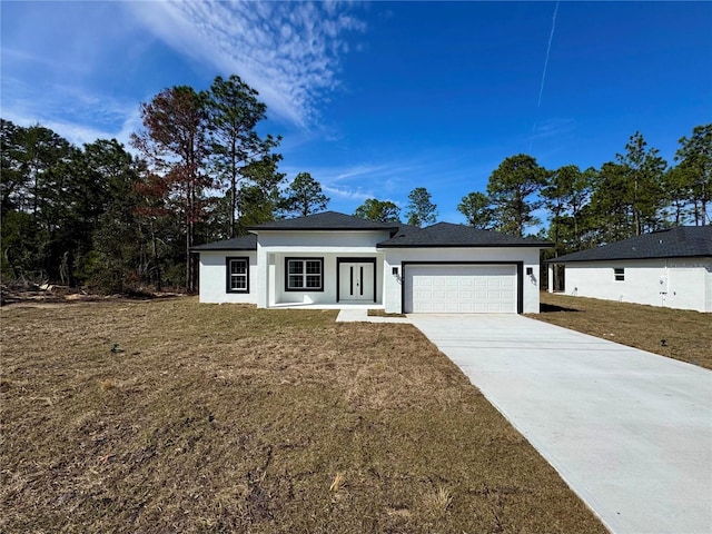 view of front of property featuring a garage and a front yard