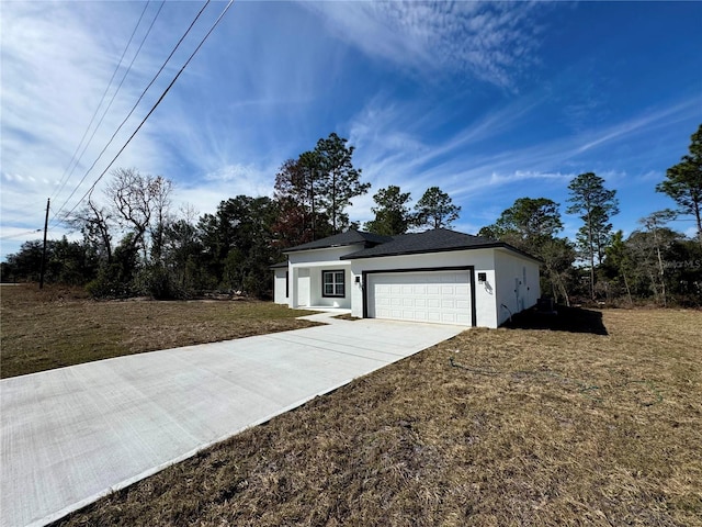 view of front of property with a garage and a front yard