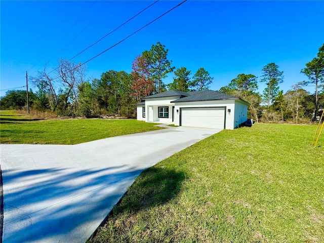 view of front of house with a front yard, concrete driveway, an attached garage, and stucco siding