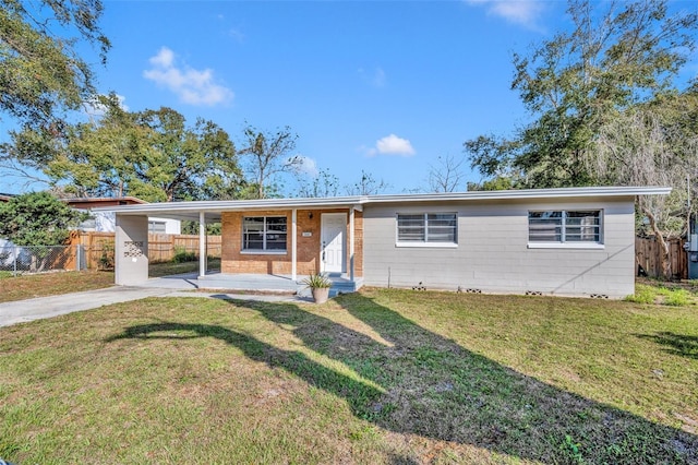 single story home with a carport, a front yard, fence, and driveway