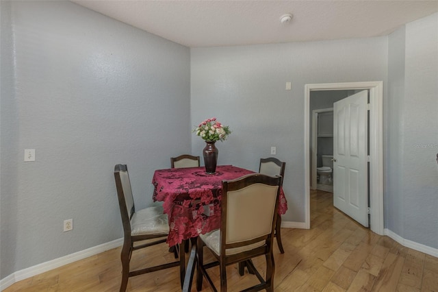 dining space with light wood-type flooring