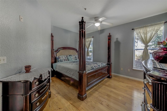 bedroom with ceiling fan and light wood-type flooring