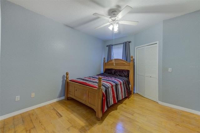 bedroom with light wood-type flooring, a closet, and ceiling fan