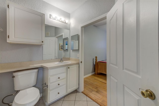 bathroom with vanity, tile patterned flooring, and toilet