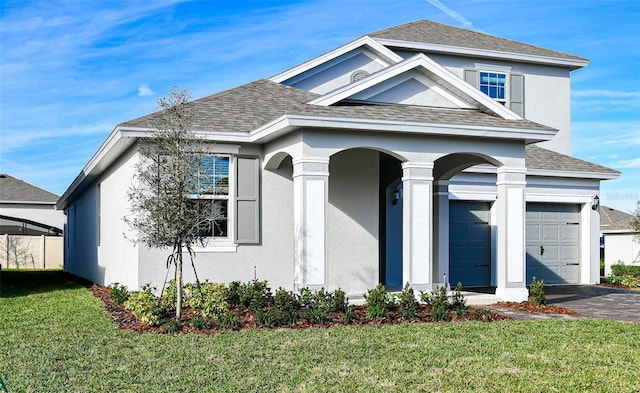 view of front of home with a garage and a front lawn