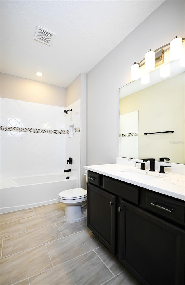 bathroom with toilet, bathtub / shower combination, visible vents, and vanity