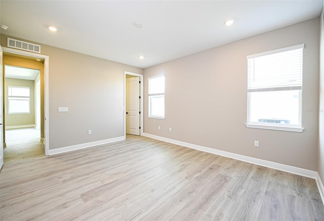 unfurnished room with light wood-style floors, recessed lighting, visible vents, and baseboards