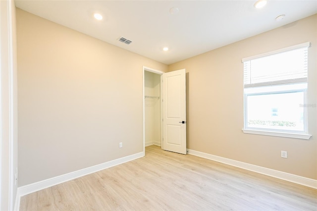 unfurnished bedroom featuring visible vents, recessed lighting, light wood-style flooring, and baseboards