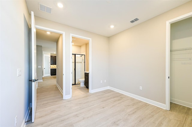 4425 Lions Gate Ave, Clermont, FL 34711 - unfurnished bedroom featuring light wood-style floors, baseboards, recessed lighting, ensuite bathroom, and a closet
