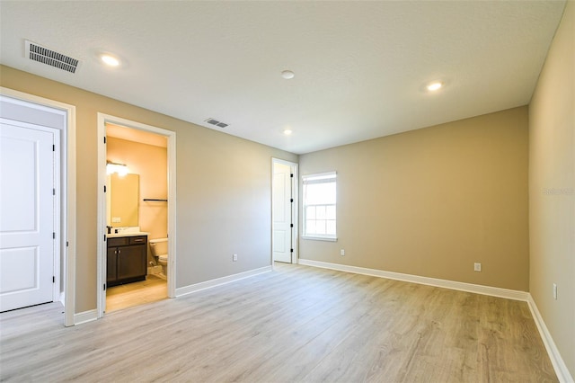 4425 Lions Gate Ave, Clermont, FL 34711 - unfurnished bedroom with light wood finished floors, baseboards, recessed lighting, and ensuite bathroom