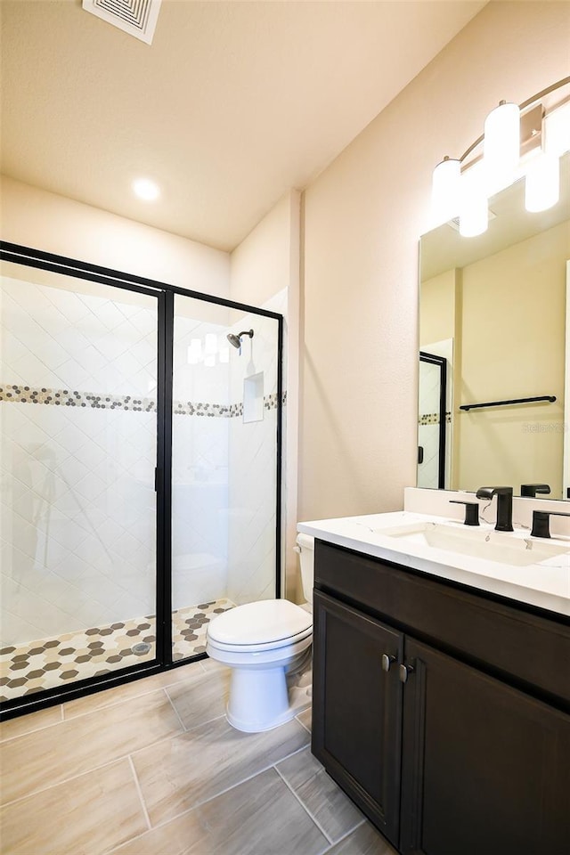 4425 Lions Gate Ave, Clermont, FL 34711 - bathroom featuring a stall shower, toilet, and vanity