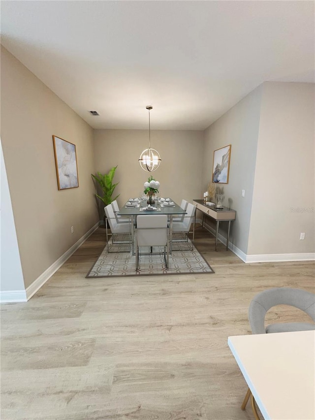 4425 Lions Gate Ave, Clermont, FL 34711 - dining space featuring wood finished floors and a chandelier